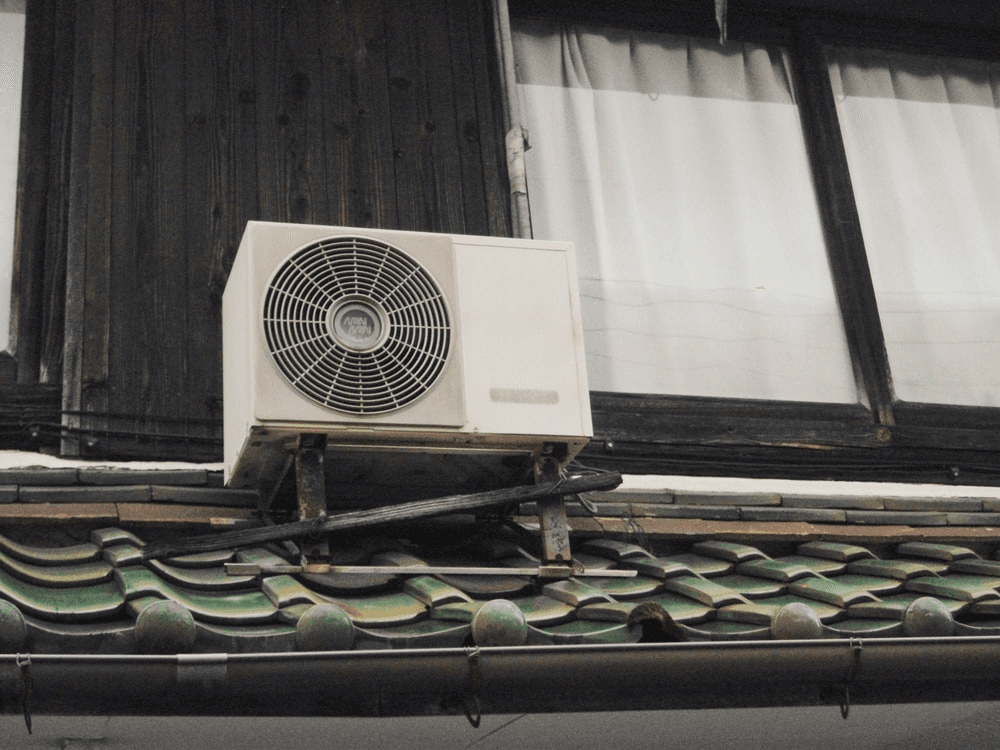 Air conditioner condenser unit placed outside the window